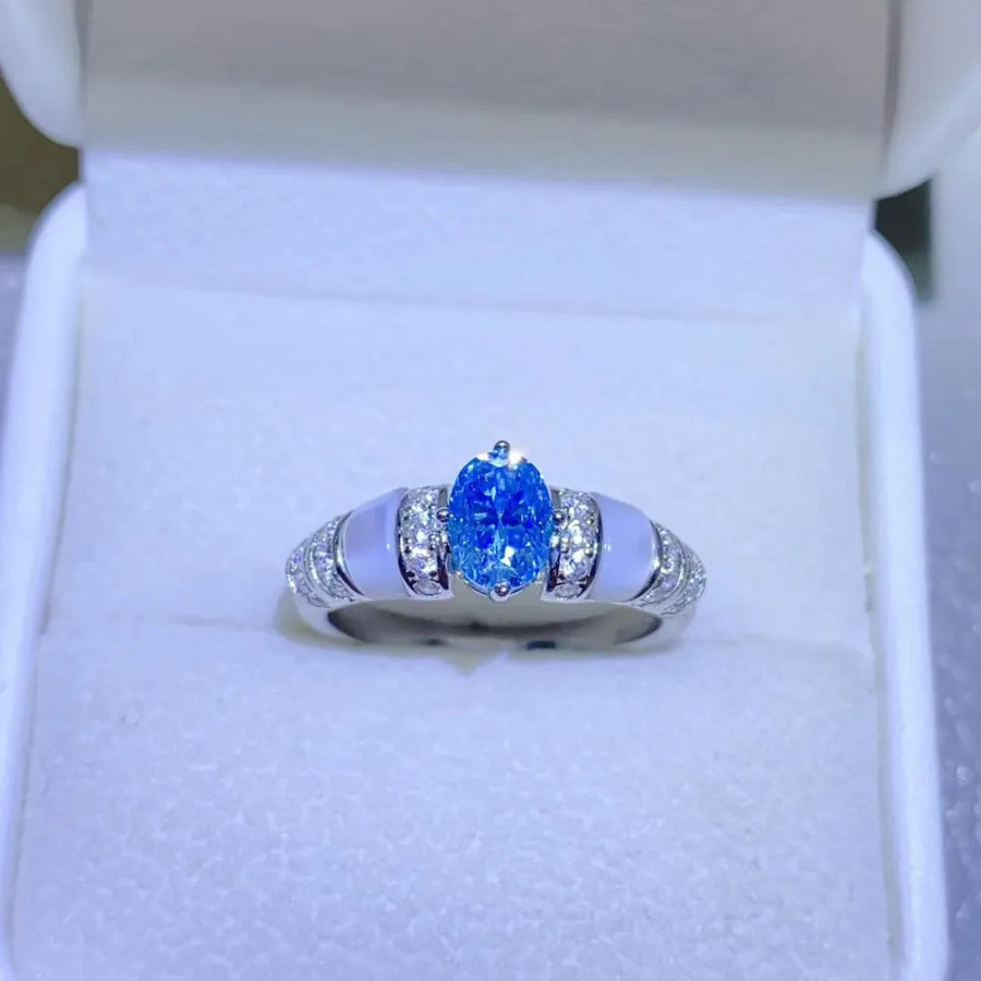 Silver ring with oval blue moissanite and mother-of-pearl accents