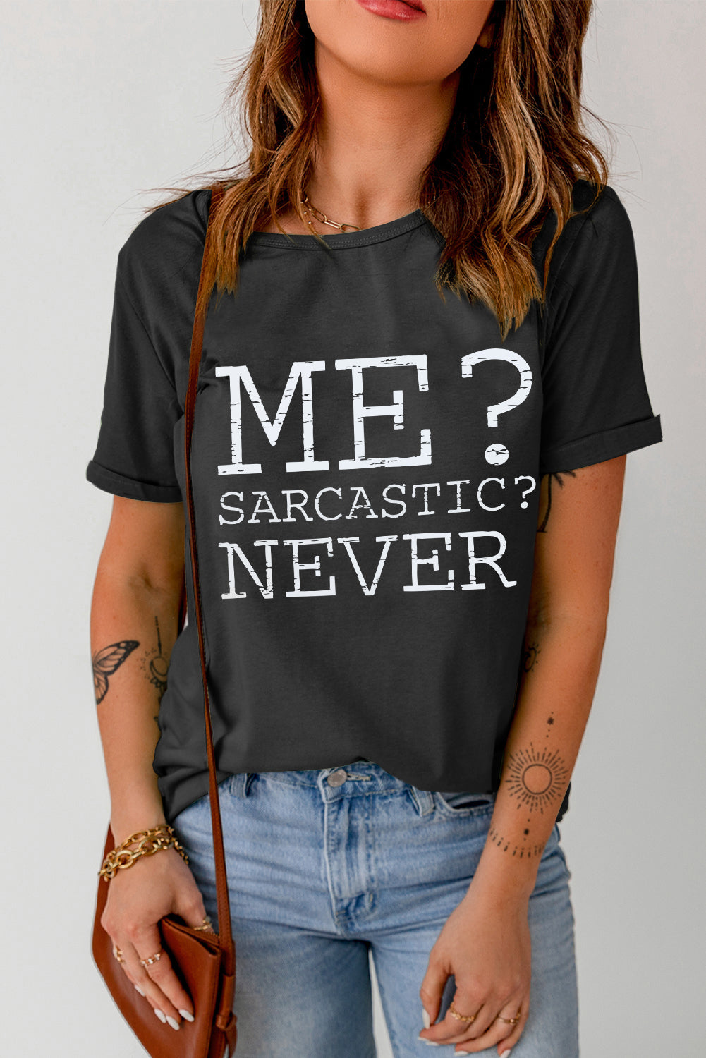 Black graphic t-shirt with "ME? SARCASTIC? NEVER" text, crew neck, short sleeves.