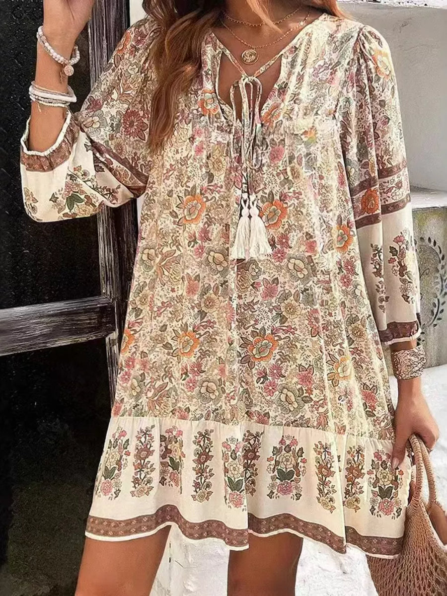 Vibrant floral print mini dress with tassel tie neckline and tiered hem