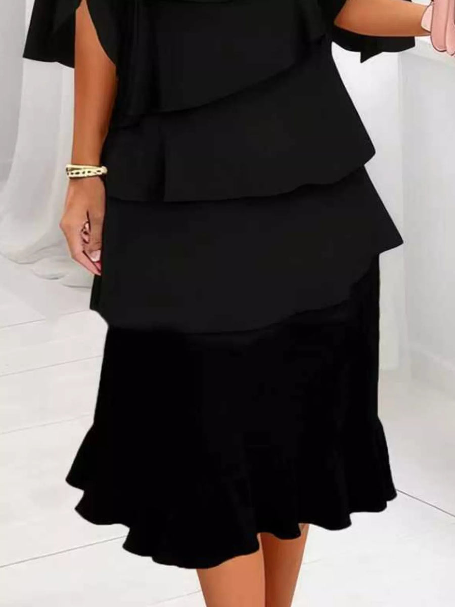 Black tiered ruffle dress with flutter sleeves and a ruffled hem.