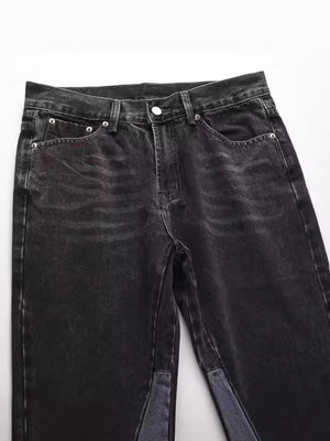 Dark wash denim bootcut jeans with raw hem and two-tone panel detail