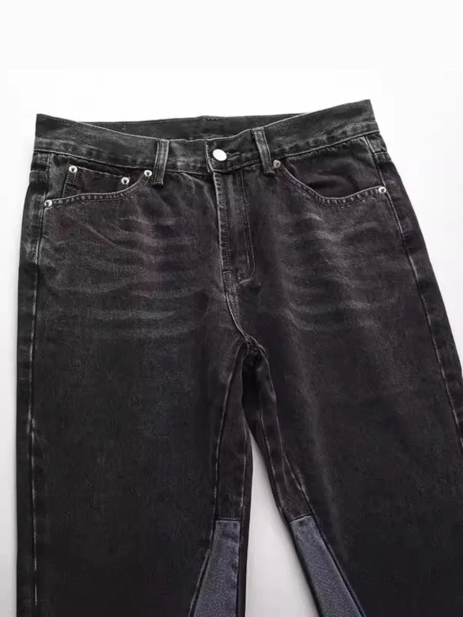 Dark wash denim bootcut jeans with raw hem and two-tone panel detail