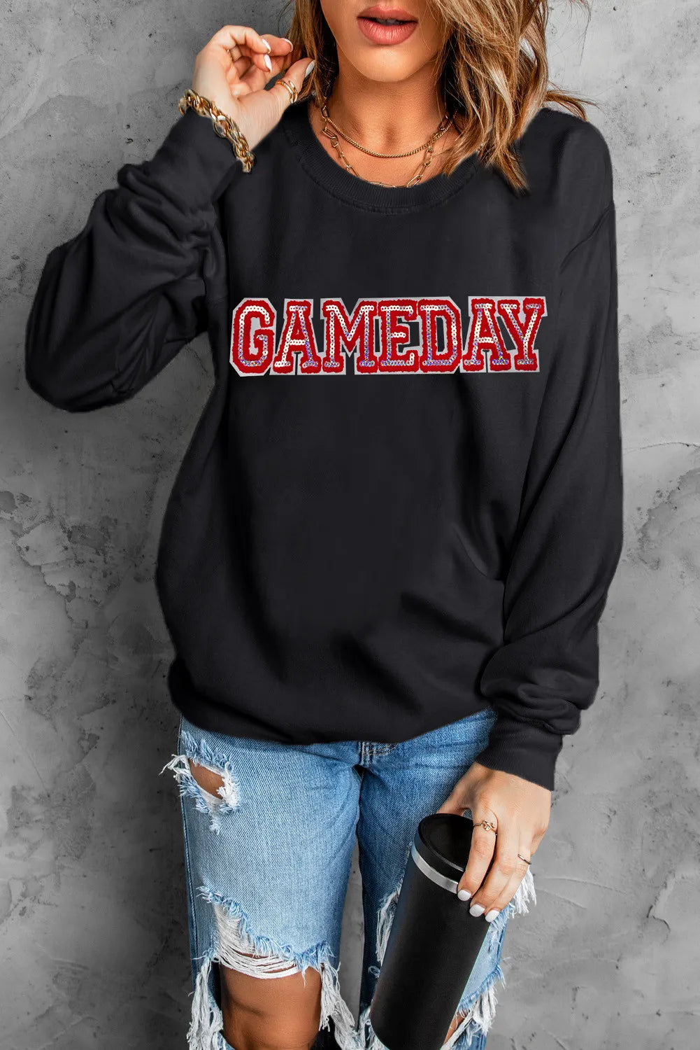 Black crewneck sweatshirt with red and white GAMEDAY appliqué, long sleeves.
