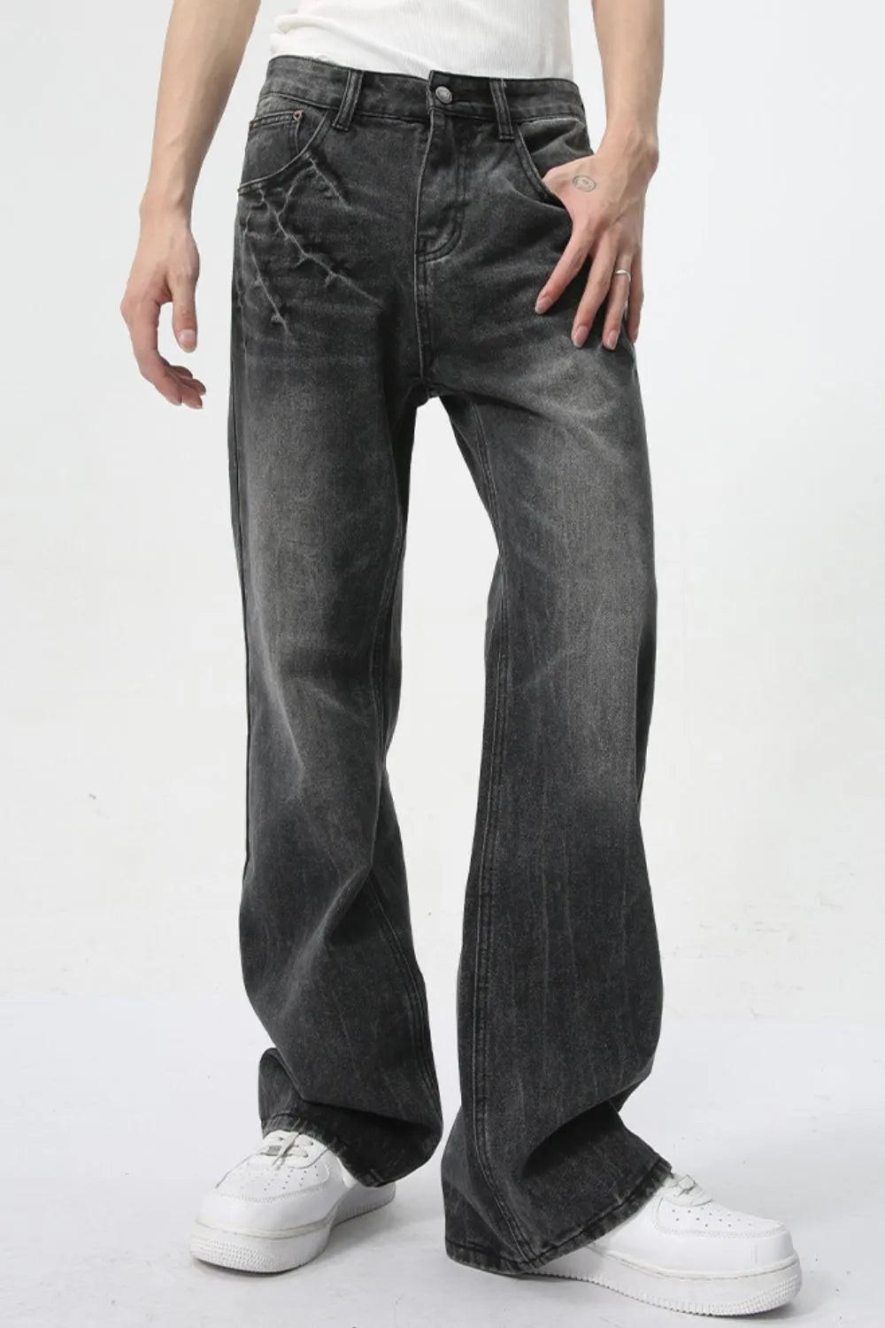 Washed black wide-leg denim jeans with a relaxed fit and subtle distressed detailing.