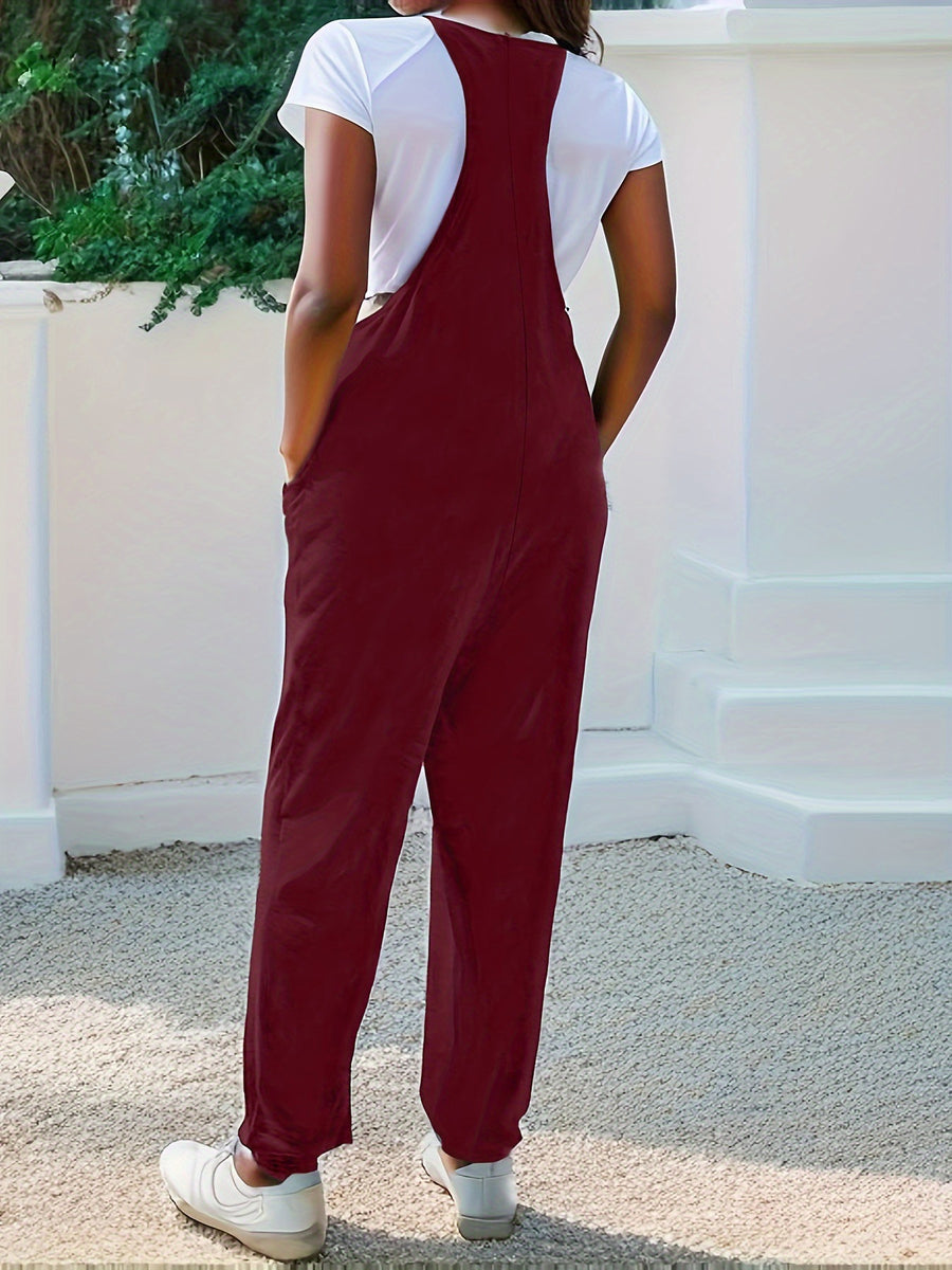 Burgundy loose fit spaghetti strap jumpsuit with pockets, styled with a white t-shirt.