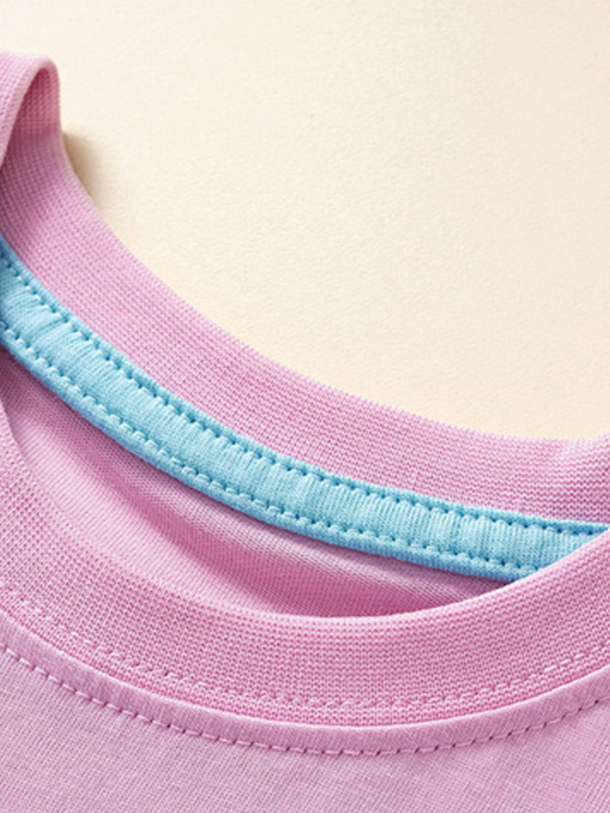 Toddler crew neck t-shirt in pink with a light blue trim detail on the neckline.