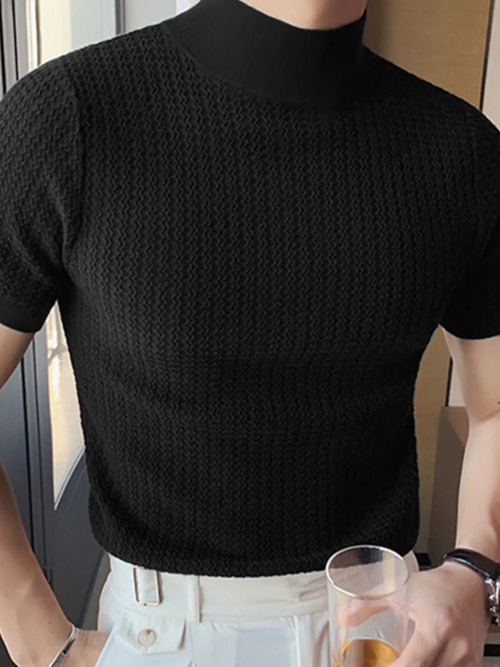Black textured knit mock neck tee with short sleeves.