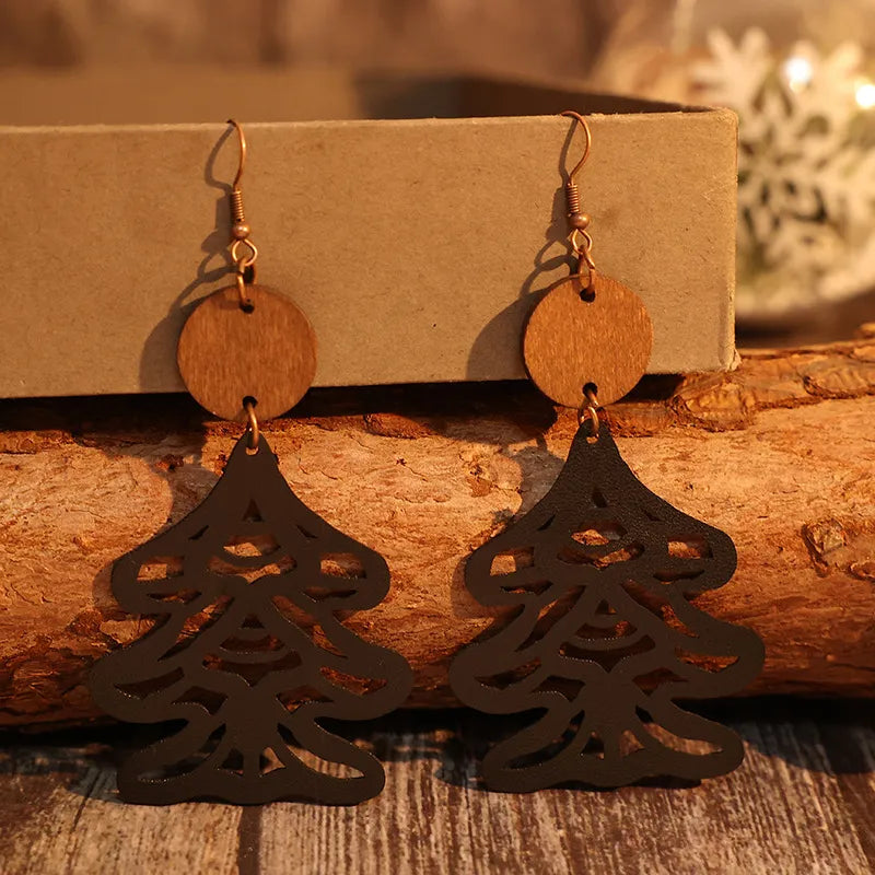 Black laser-cut pine tree earrings with wood circle tops.