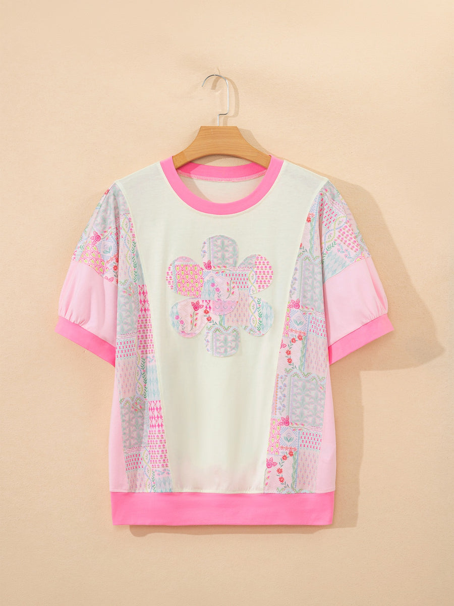 Maternity t-shirt with crew neck, short sleeves, floral patchwork pattern, and pink accents.