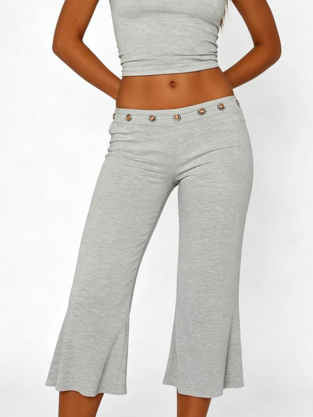 Light gray flared hem capri pants with button detail at waist