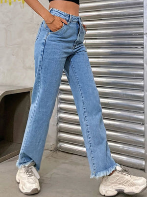 Light wash denim jeans with frayed hem and chain detail.