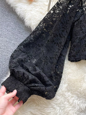 Black sheer floral lace shirt with balloon sleeves and tie-back detail.
