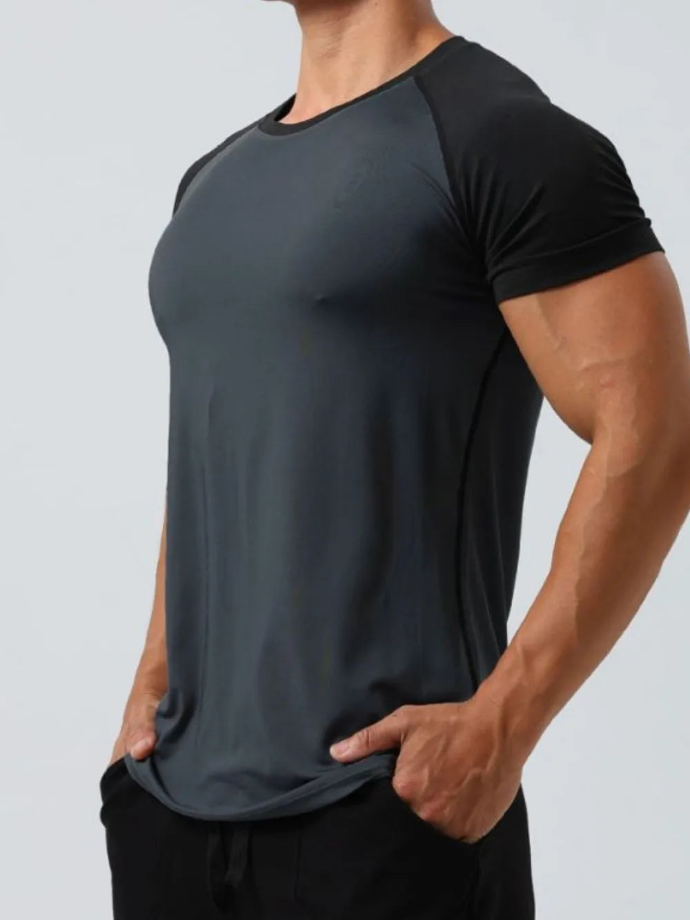 Raglan sleeve performance tee in gray with black sleeves and crew neck.
