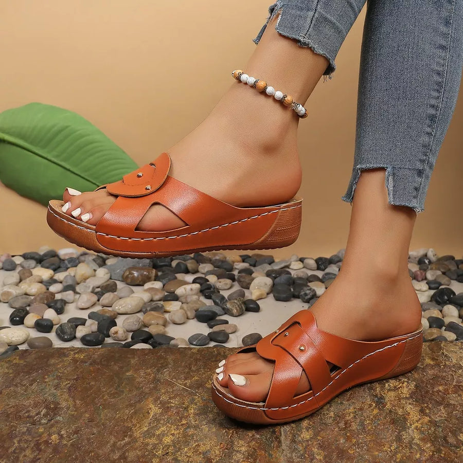 Chic slip-on wedge sandals in orange with riveted detail and cut-out straps.