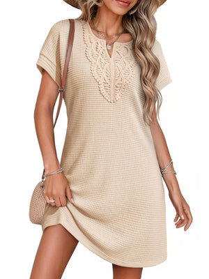 Apricot waffle knit dress with lace neckline detail and short sleeves.