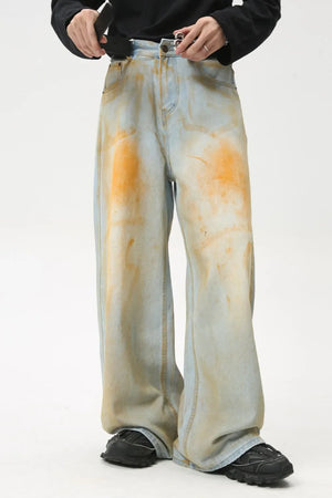 Acid wash palazzo denim jeans in light blue with orange splatters, wide leg.