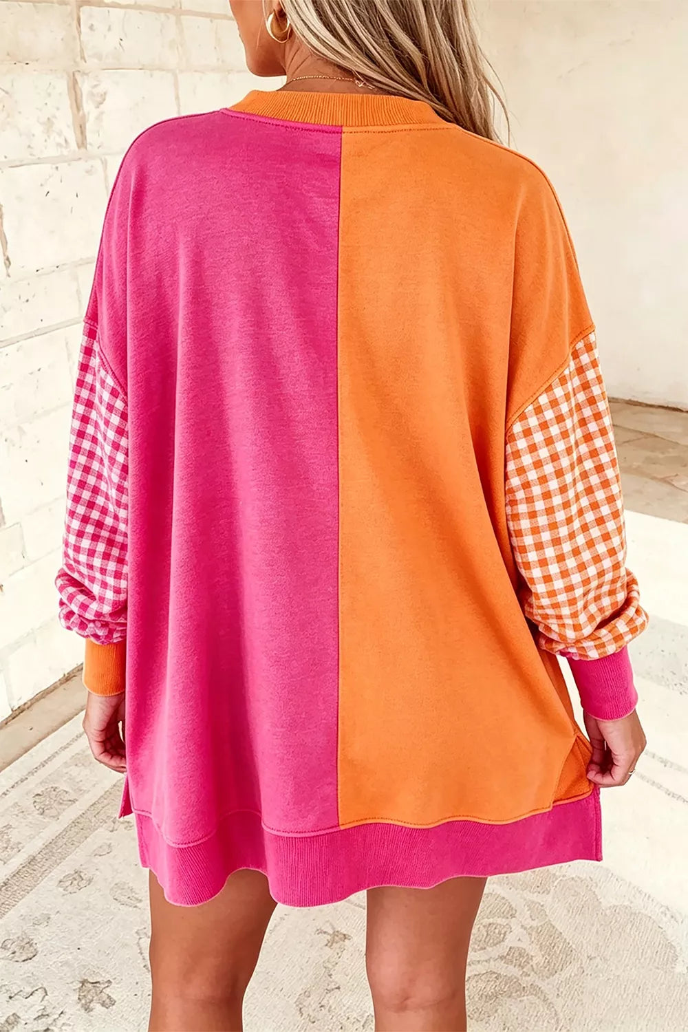 bright orange sweatshirt featuring oversized and color-block