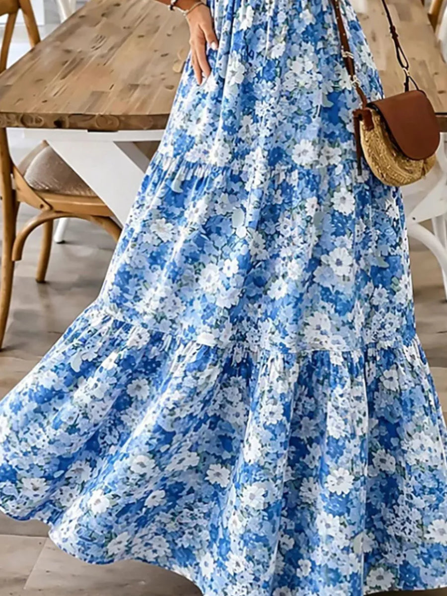 Floral tiered maxi dress in Sky Blue with spaghetti straps and a flowing skirt.