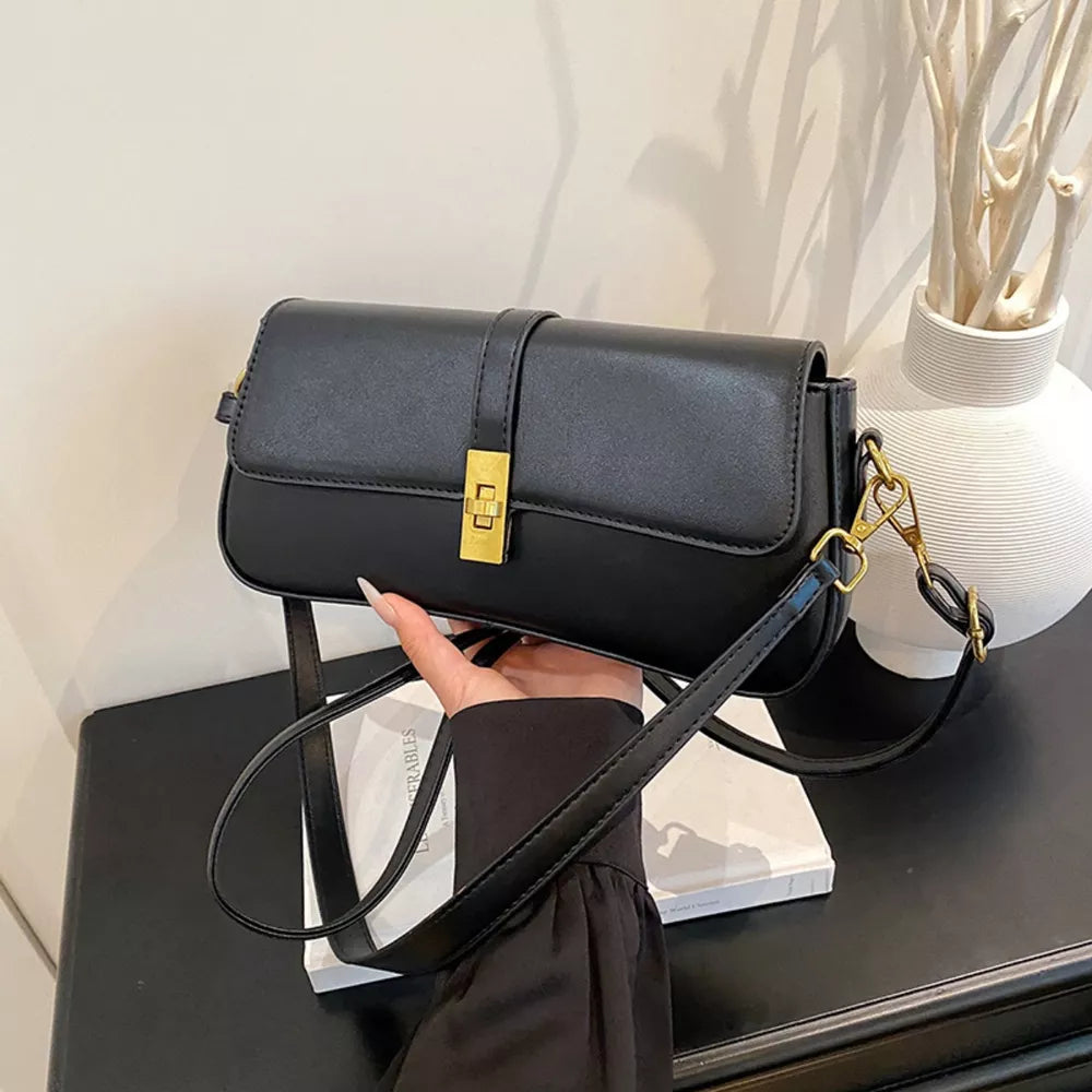 Sleek black rectangular crossbody bag with gold clasp and strap hardware.