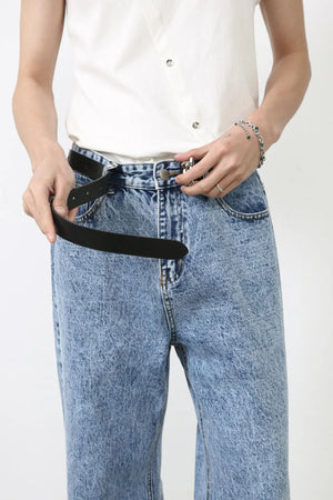 Acid wash wide-leg jeans in medium blue denim, shown with a black belt being fastened.