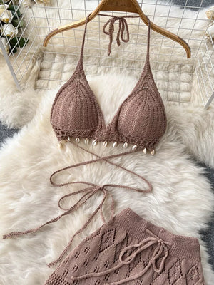 Khaki crochet halter bikini top with shell trim and wide-leg pants.