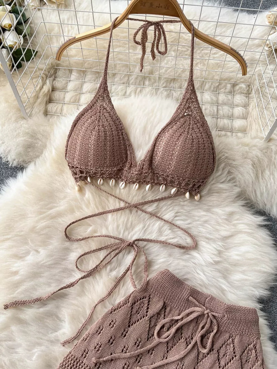 Khaki crochet halter bikini top with shell trim and wide-leg pants.