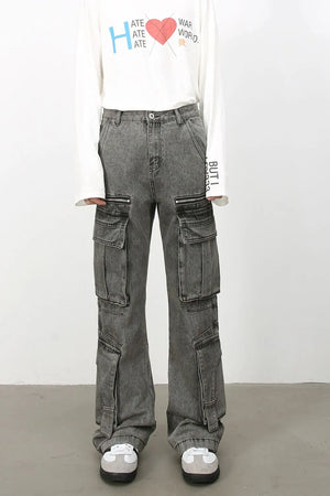 Acid wash flared cargo jeans in medium with multiple pockets and zipper details.