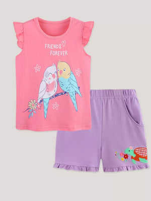 Pink graphic t-shirt with ruffled sleeves and purple ruffled shorts with turtle embroidery.