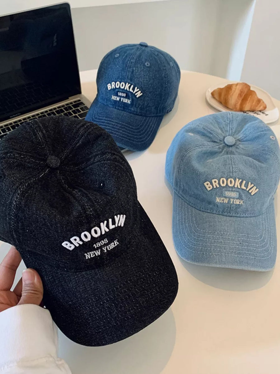 Brooklyn letter-embroidered baseball cap in black, dark blue, and light blue denim.
