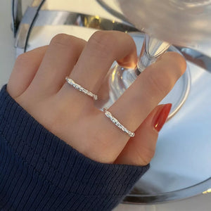 ring in silver featuring textured and open fit