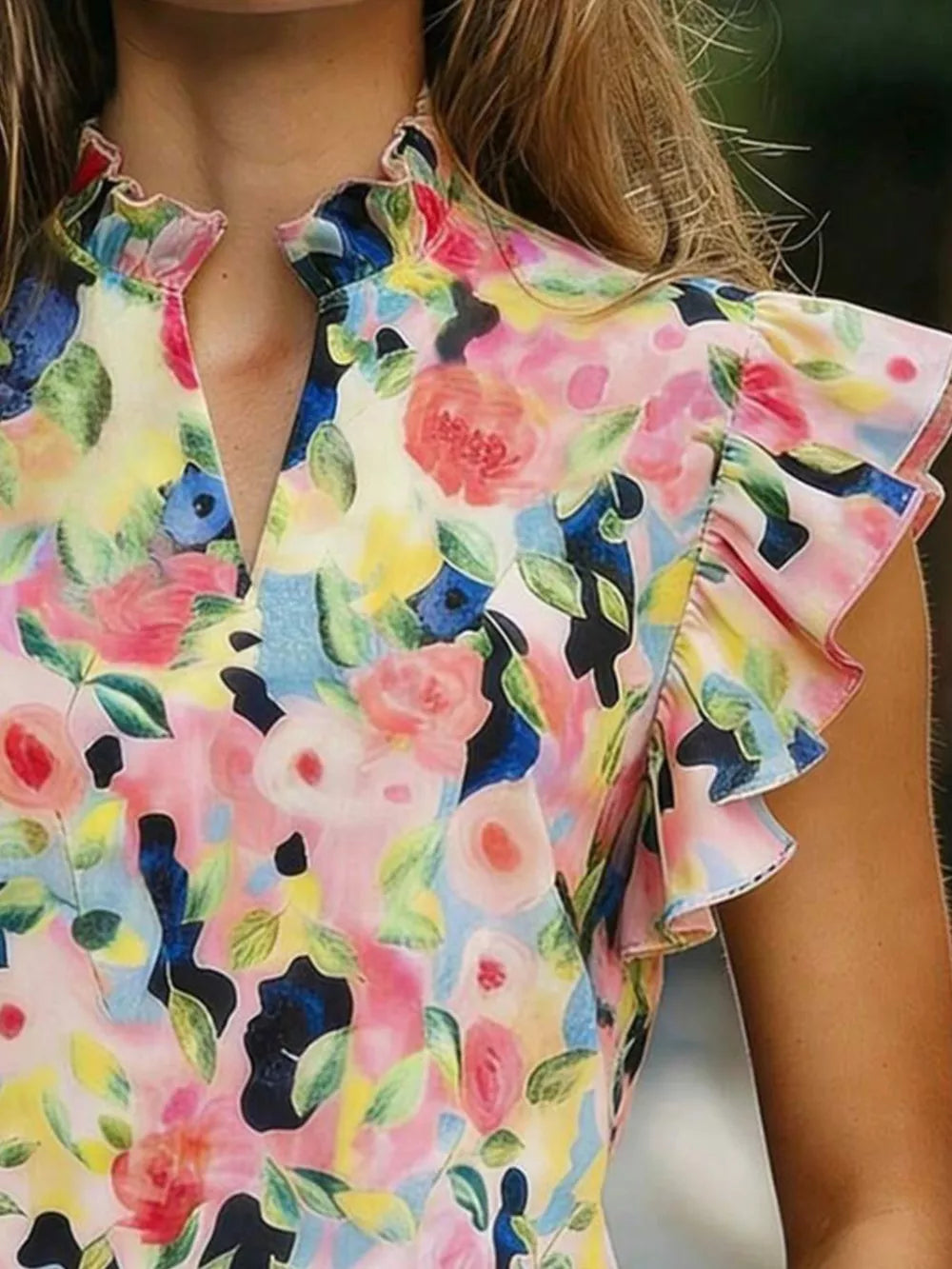 Floral print t-shirt with ruffled collar and sleeves in a multicolor abstract floral pattern.
