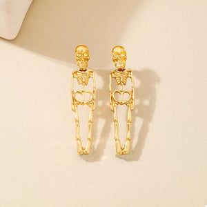 Gold earrings featuring dangle and skeleton