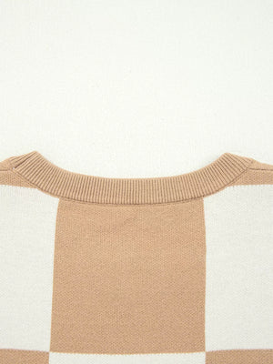 Drop shoulder sweater in camel and white checkerboard pattern with ribbed crew neck.