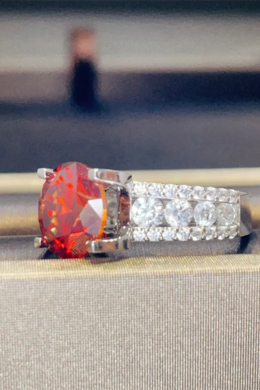Crimson solitaire ring with pave diamond band in silver.