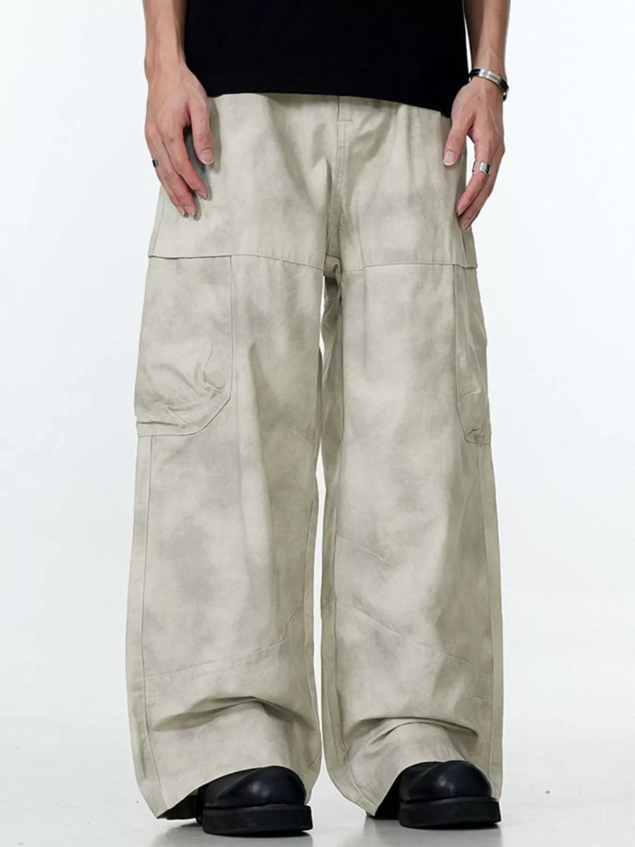 Relaxed fit beige cargo pants with a tie-dye effect and multiple pockets.