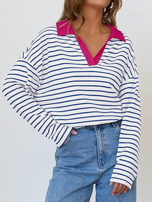 Oversized striped long-sleeve sweatshirt with a bright pink collar and V-neck.