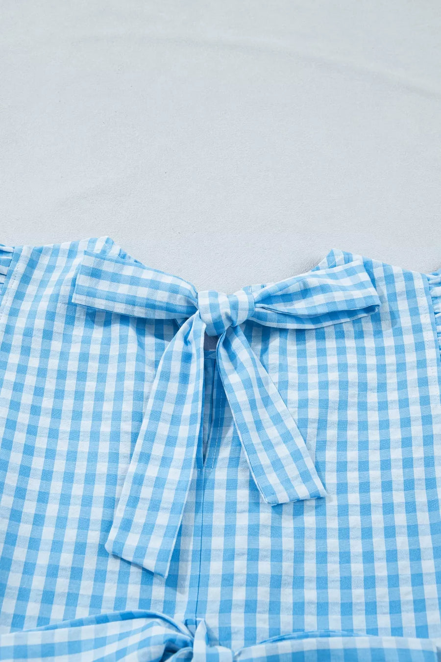 Blue gingham maternity maxi dress with ruffled tiers and knot back detail