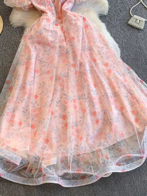 Light pink floral maxi dress with glitter and sheer overlay, sweetheart neckline, short sleeves.