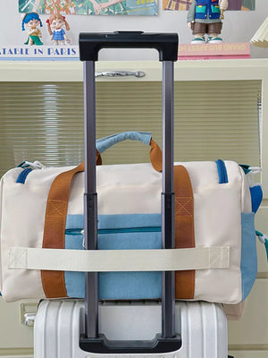 Vibrant multi-pocket nylon travel bag with color block detail and tan straps.