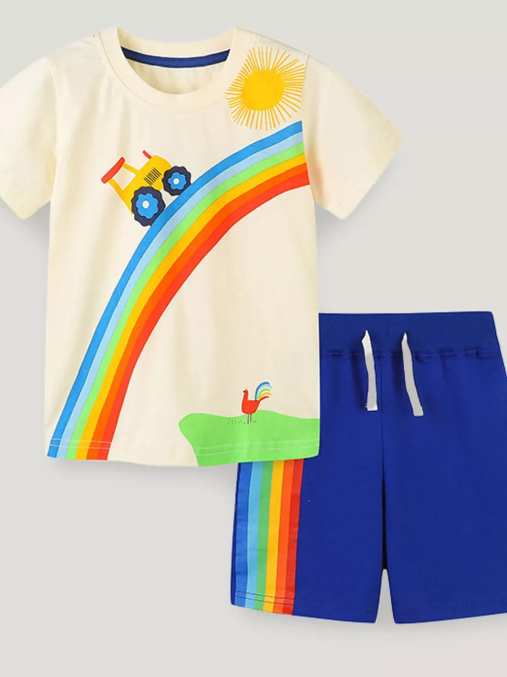 Cream tractor rainbow toddler t-shirt and blue shorts set with rainbow trim.