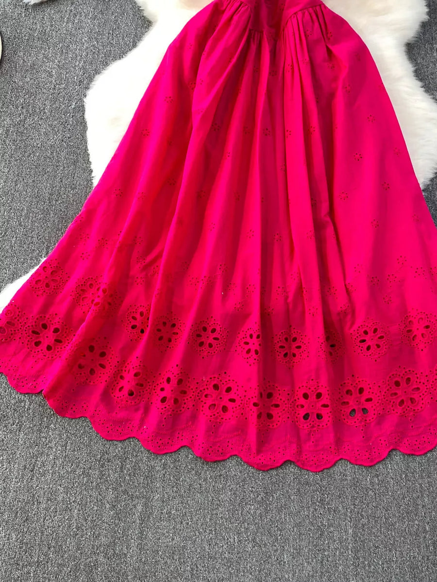 Charming eyelet maxi dress in bright red with scalloped hem and floral cutouts.
