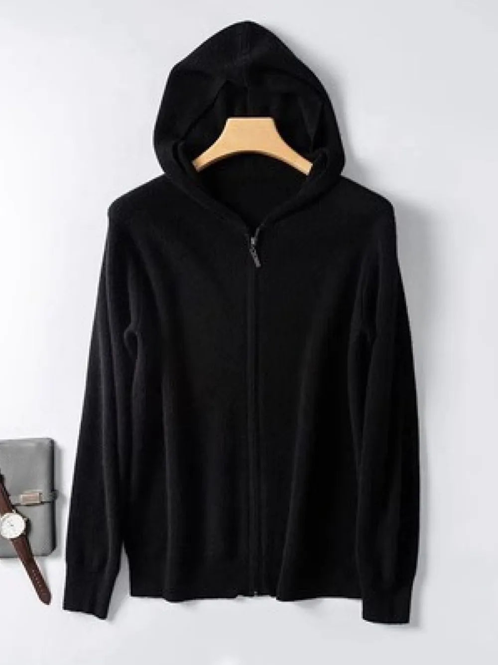 Black cashmere hooded zip-up sweater with a full zipper closure.