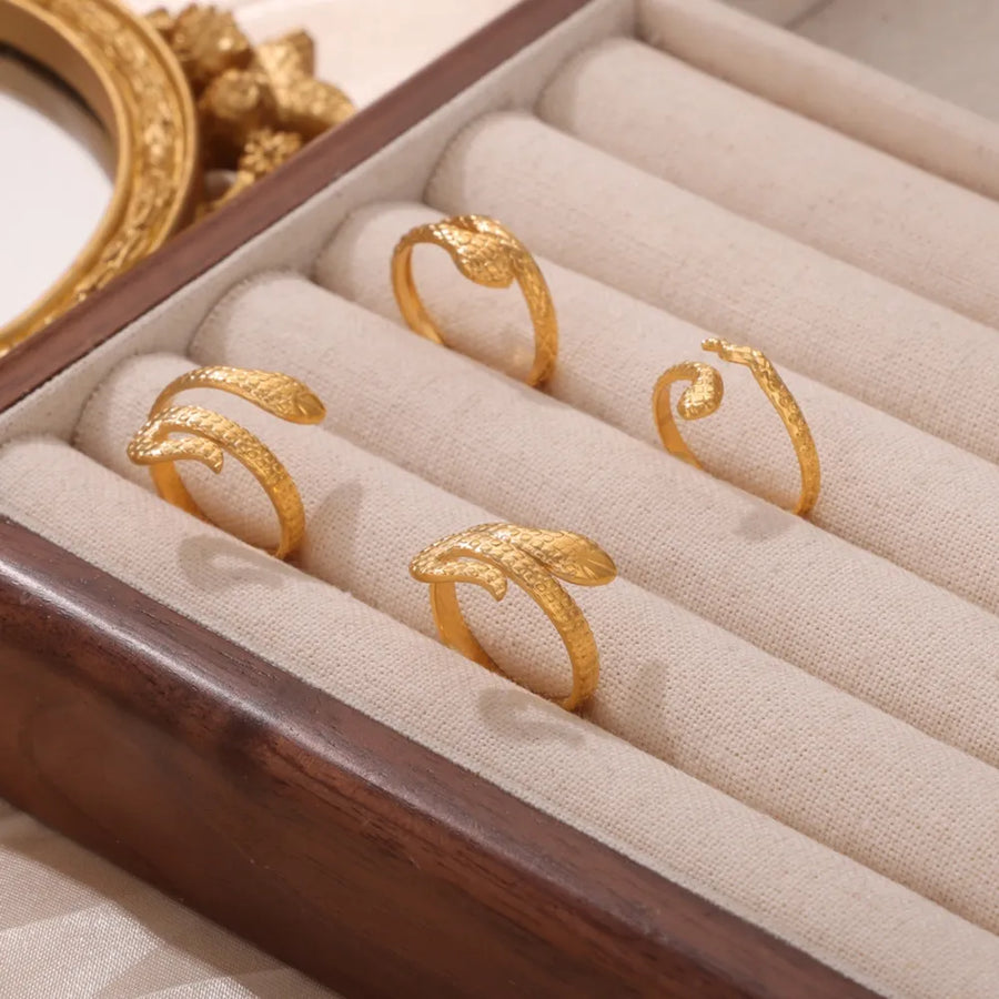 Gold textured snake wrap rings in a jewelry box.