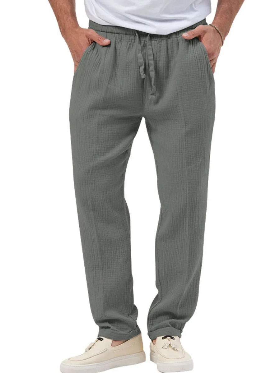 Textured drawstring linen blend trousers in dark gray with a relaxed fit and cuffed ankles.