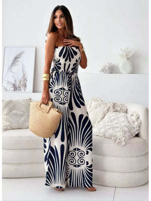Strapless wide-leg romper in black and white tribal print polyester with smocked bodice.
