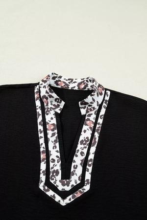 Black polyester tunic with leopard print notched neckline and trim