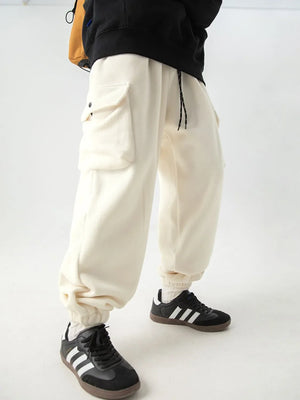 Ivory fleece cargo jogger trousers with drawstring and button flap pockets.