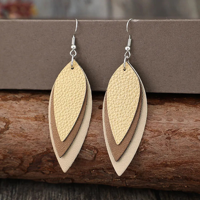 Layered tan leatherette leaf earrings with silver hooks.