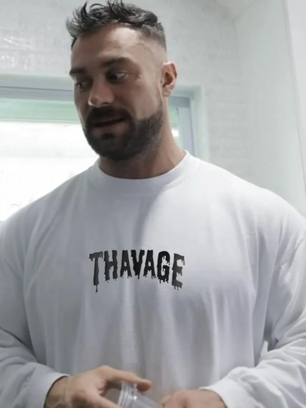 White long sleeve t-shirt with black dripped logo graphic on chest