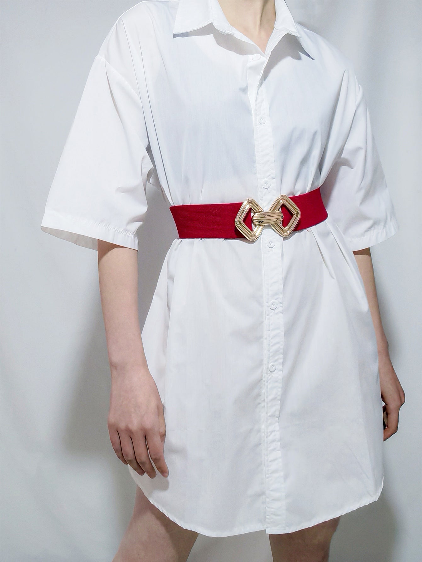 Red elasticated waist belt with gold geometric buckle detail